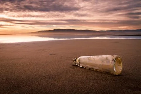 Bottle on the beach with important message Stock Photos