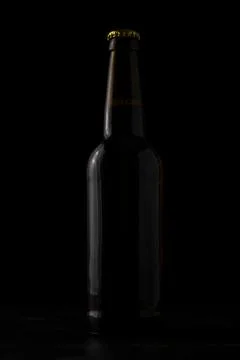A bottle of beer on a black background Stock Photos