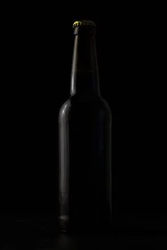 A bottle of beer on a black background Stock Photos