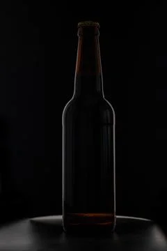 A bottle of beer on a black background Stock Photos