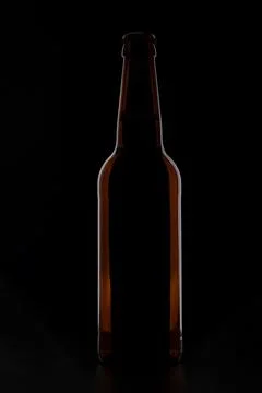 A bottle of beer on a black background Stock Photos