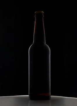 A bottle of beer on a black background Stock Photos