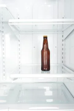 Bottle of beer in refrigerator Stock Photos