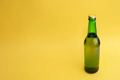 A bottle of beer on a yellow background Stock Photos