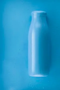 Bottle on blue background Stock Photos