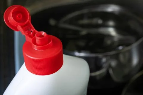 Bottle cap of dish soap on background of sink with dishes Stock Photos