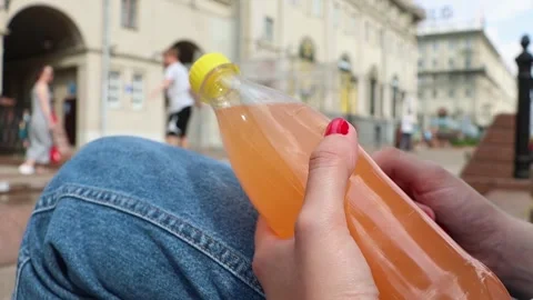 A bottle with a carbonated drink in the hands Stock Footage 244332190