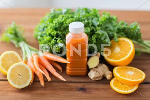Bottle with carrot juice, fruits and vegetables Stock Photos