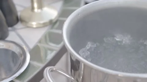 A bottle of champagne is put back in a bucket of ice, then covered with a towel Stock Footage 135399407