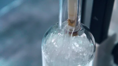 Bottle of clear brandy filling during distillery bottling process Stock Footage 86711573