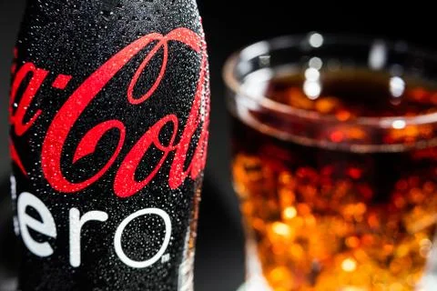 Bottle of Coca Cola Zero with drops and Glass with the Ice Cubes Stock Photos