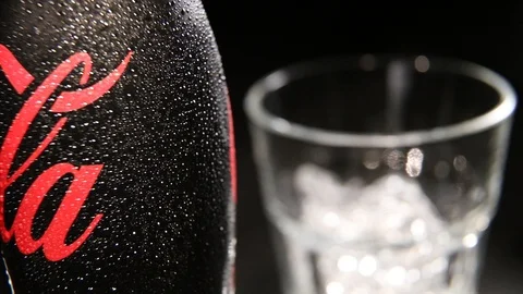 Bottle of Coca Cola Zero with Water drops and Glass with the Ice Cubes Stock Footage 99843439