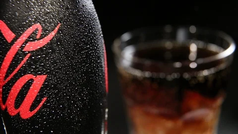 Bottle of Coca Cola Zero with Water drops and Glass with the Ice Cubes Stock Footage 99843568