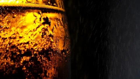 A bottle of cold beer with water splash in slow motion on a black background Stock Footage 115631689