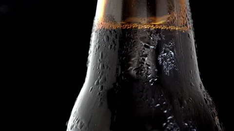 A bottle of cold black beer on a black background. Stock Footage 111374033