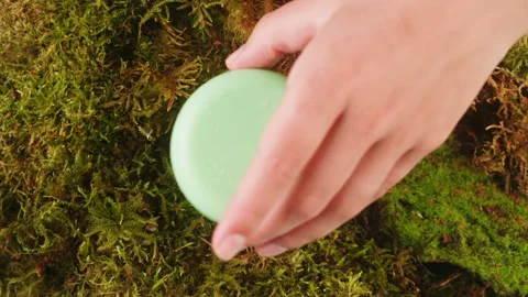 Bottle of cosmetics cream serum on moss forest background green leaves. Woman Stock Footage 252085035