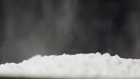 A bottle of cosmetics falls into the powder Stock Footage 262064375