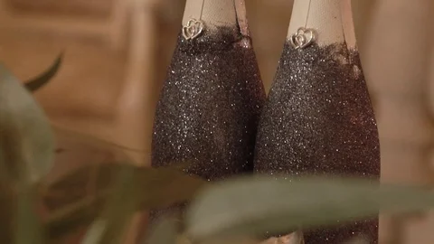 A bottle decorated on a table with artificial flowers decorated by a florist Video stock 122999790