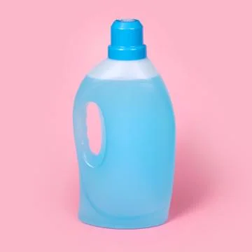 Bottle of detergent on pink background. Plastic container of cleaning product Stock Photos