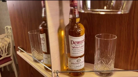 Bottle of dewar’s white label on shelf in bar, Perm, RUSSIA, 10 June 2021. Stock Footage 155472642