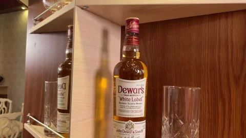 Bottle of dewar’s white label on shelf in bar Stock Footage 160951621