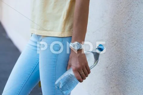 Bottle of drinking water in a female hand closeup Stock Photos