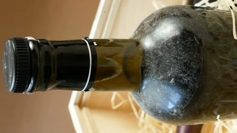 Bottle of expensive elite wine in a wooden box with shavings,  online order a Stock Footage 148391653