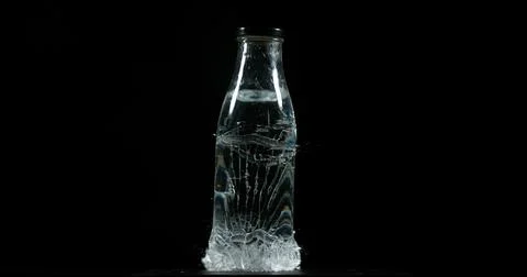 Bottle Falling and exploding on Black Background Foto stock
