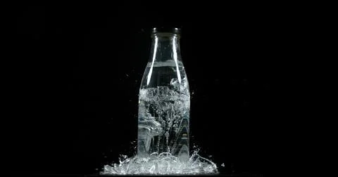 Bottle Falling and exploding on Black Background 스톡 사진