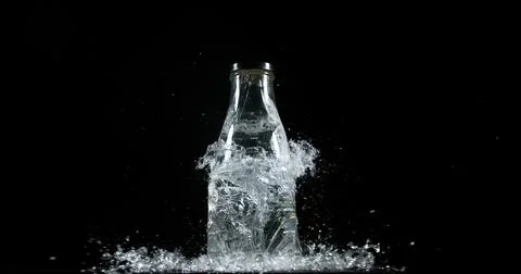 Bottle Falling and exploding on Black Background 写真素材