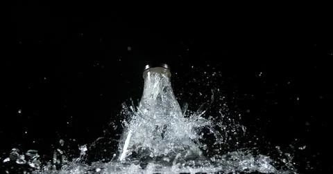 Bottle Falling and exploding on Black Background Foto stock