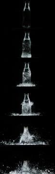 Bottle Falling and exploding on Black Background 스톡 사진