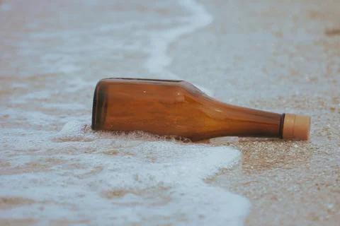 Bottle floating on the sea Stock Photos