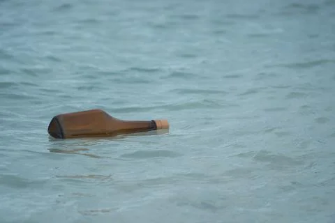 Bottle floating on the sea Stock Photos
