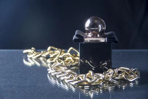 A bottle of fragrant perfume on a dark background. Women's perfumes. Mystical Stock Photos