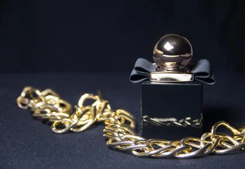 A bottle of fragrant perfume on a dark background. Women's perfumes. Mystical Stock Photos
