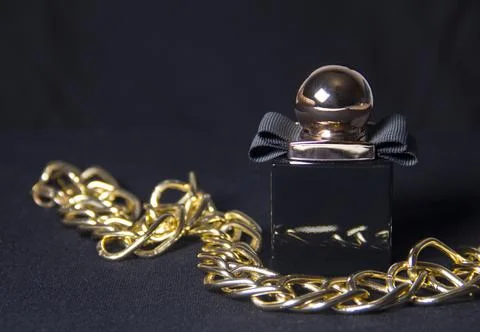 A bottle of fragrant perfume on a dark background. Women's perfumes. Mystical Stock Photos