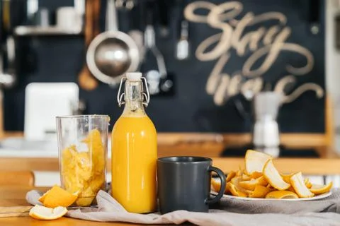 Bottle of fresh orange juice squeezed just at home in a rustic style kitchen. Stock Photos