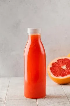 A bottle of freshly squeezed grapefruit juice. Detox concept. Stock Photos