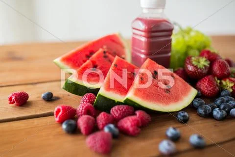 Bottle with fruit and berry juice or smoothie Stock Photos