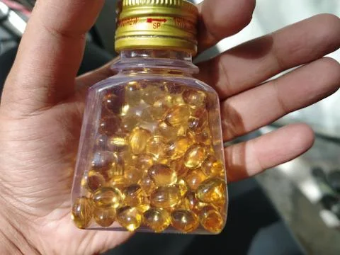 A bottle full of medicinal tablets that can help cure disease. Stock Photos