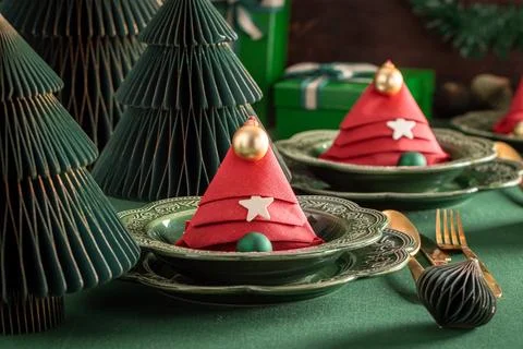Bottle green dining setup with festive baubles. Stock Photos
