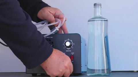Bottle of iced water being ozonated with a round ozonating stone. Tubes leadi 스톡 동영상 143284527