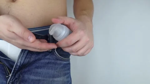 Bottle intimate lubricants. The man has intimate gel in his pocket. A male torso Stock Footage 262425853