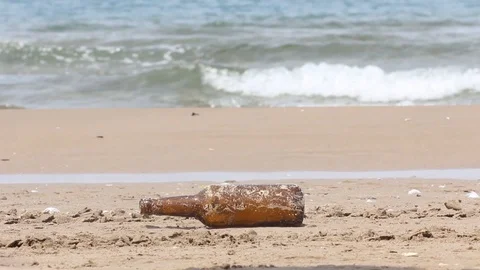 Bottle left near a beach close Stock Footage 102436638