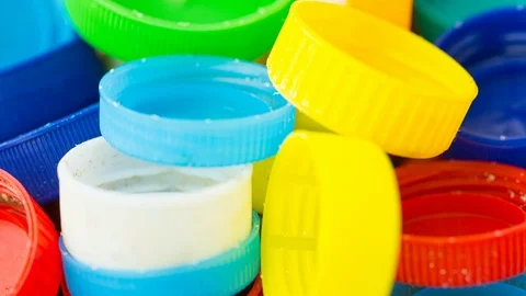 Bottle lids tracking shot plastic waste macro Video stock 115282937