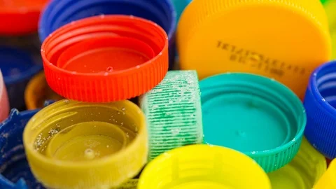 Bottle lids tracking shot plastic waste Stock Footage 115428588