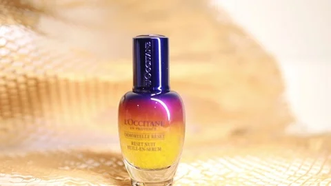 A bottle of Loccitane oil serum on the table Stock Footage 154010336