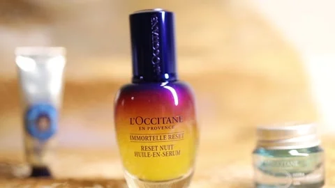 A bottle of Loccitane oil serum on the table Stock Footage 154010337