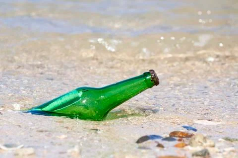 Bottle with message on the beach Stock Photos